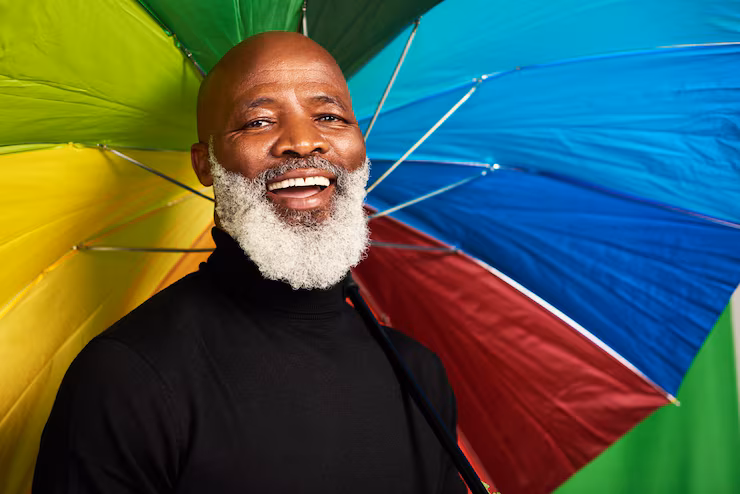 portrait-smile-mature-black-man-with-umbrella-rainbow-pride-with-creative-style-cover-life-insurance-happy-face-male-person-with-color-confidence-protection-with-premium-care_590464-509839
